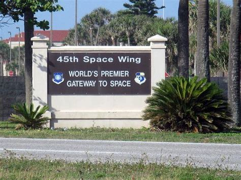 A Sign For The World S Premier Gateway To Space In Front Of Palm Trees