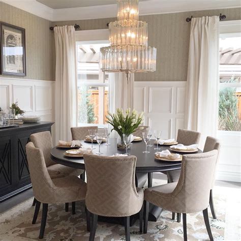 An Elegant Dining Room With Chandelier And Round Table