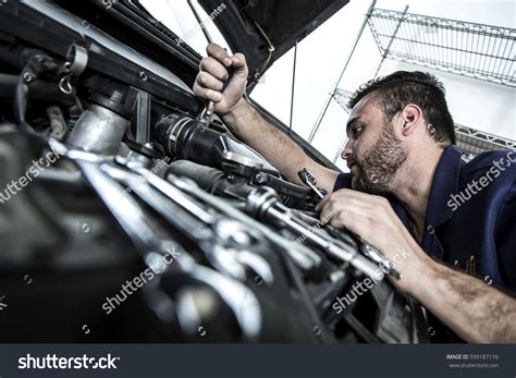 Car Mechanic Man Garage Fixing Engine Stock Photo Edit Now 599187116