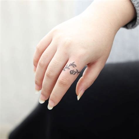 Floral Ring Tattoo Located On The Finger