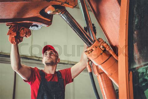 Heavy Machinery Mechanic Performing Tractor Maintenance Stock Image