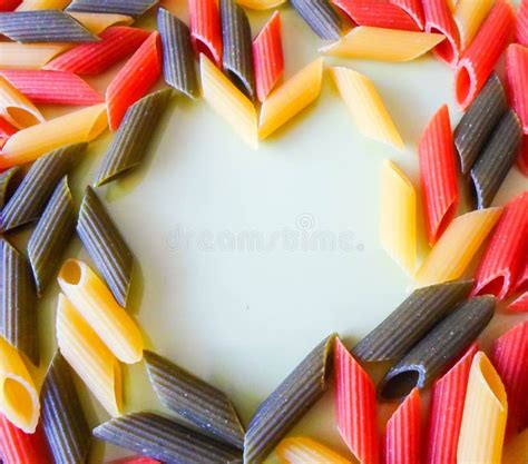 Multi Colored Pasta In Plates In The Form Of A Heart On A White Table