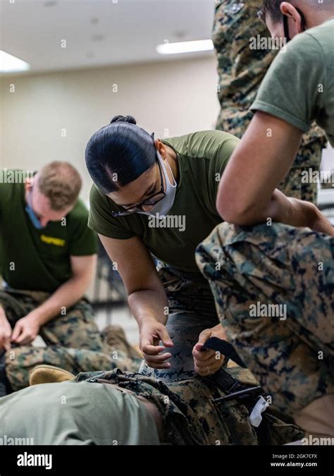 U S Marine Corps Lance Cpl Nichole Lopez Martinez An Inventory Management Specialist With 3D Supply Battalion 3D Marine Logistics Group And Davenport Florida Native Applies A Tourniquet During A Tactical Combat Casualty Care