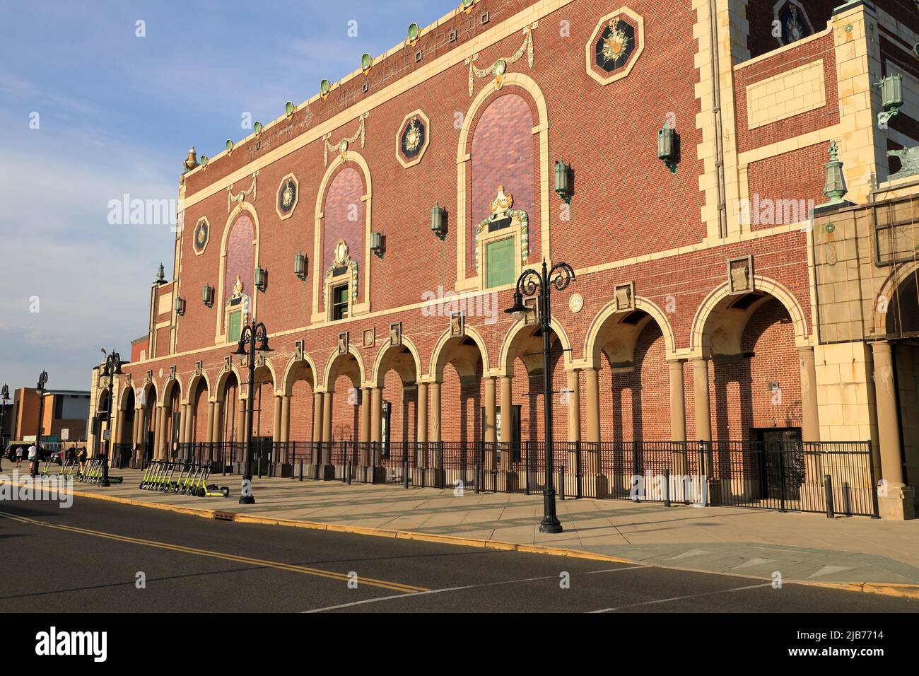 Visitors On Asbury Park Beach Boardwalk With Convention Hall In The